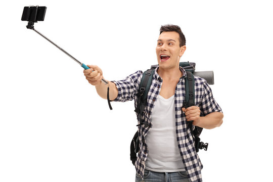 Young hiker taking a selfie with a stick