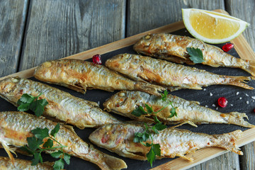 fried fish goatfish surmullet with lemon on board