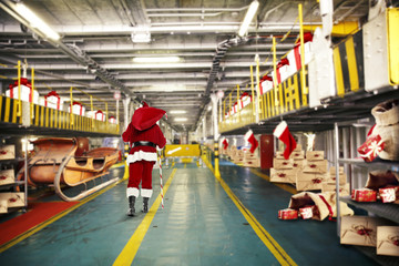 santa claus and elf in interior 