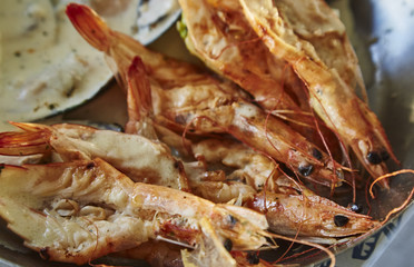 tasty shrimps, mussels, fish with lemon on metal plate
