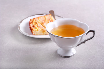 Cup of tea and plate with dessert