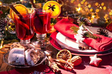 Red mulled wine with cinnamon sticks and orange slices