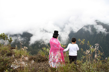 Obraz premium Bolivian mother and child enjoy the view of the mountains, Death road, Yungas region, Bolivia, South America