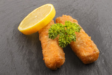 fish finger with parsley and lemon on slate