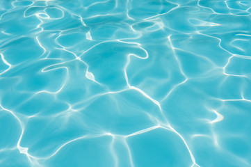 Fototapeta na wymiar Ripple Water in swimming pool with sun reflection