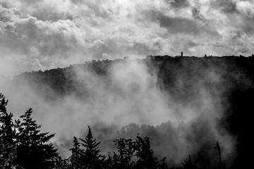 Mist, fog and clouds above the old town.
The weather changes dynamically above Tuscany, Italy. Road view.