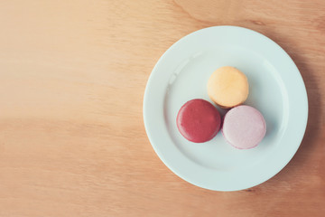 Sweet and colourful french macarons on wood