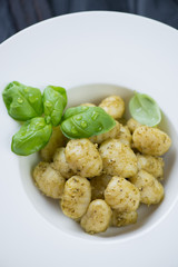 Close-up of potato gnocchi served with basil pesto sauce