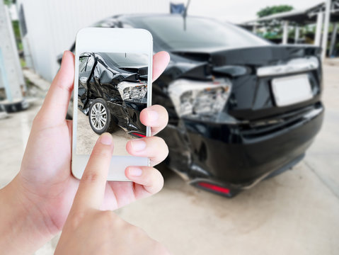 female hold mobile smartphone photographing car accident