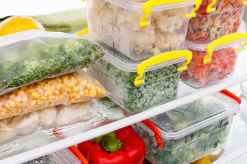 Frozen food in the refrigerator. Vegetables on the freezer shelves. - obrazy, fototapety, plakaty