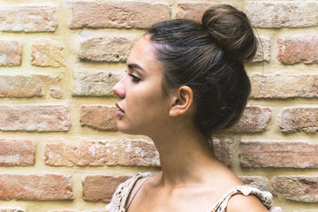 Close up profile portrait of an attractive pretty young woman chignon hairstyle - Stunning girl...