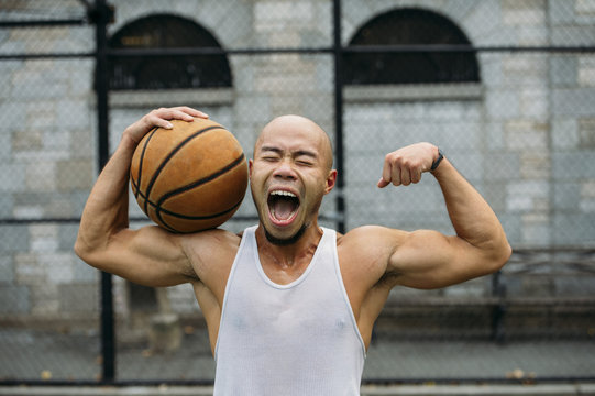 Happy basketball player screaming on court
