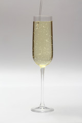 champagne is poured into a glass