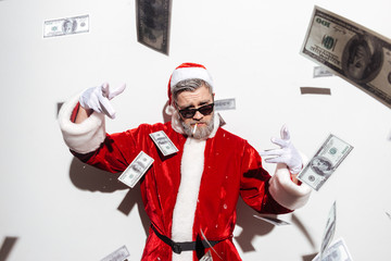 Stylish santa claus in sunglasses smoking and throwing money - Powered by Adobe