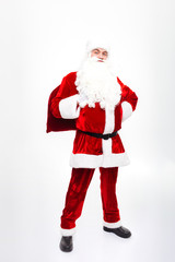 Smiling man santa claus standing and holding present sack