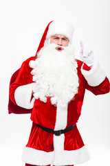 Man santa claus with gift sack talking and pointing up