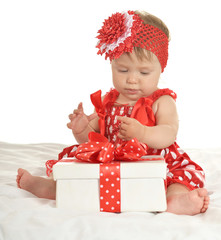 Baby girl in   dress  with gift