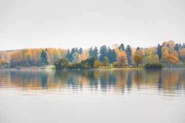 Raspberry island on lake Senezh in Solnechnogorsk fall in the fog in calm weather. Autumn water landscape