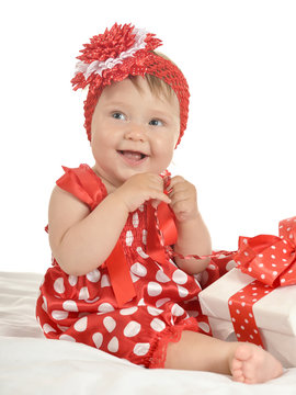 Baby girl in   dress  with gift
