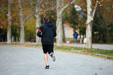 Back view of runner in park