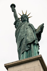 Fototapeta premium Replica of the Statue of Liberty near the Eiffel Tower on the Isle of the Swans, a man-made island in the Seine. (Paris, France)