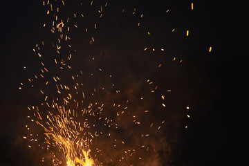 bonfire spark in the dark sky in night, shallow focus
