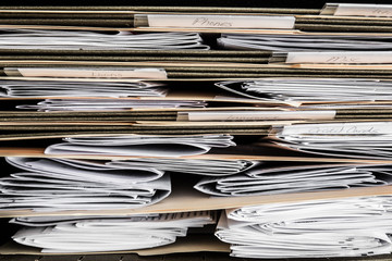 Stack of papers, bills, invoices and financial statements in files