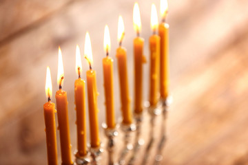Menorah with candles for Hanukkah on blurred wooden background, close up © Africa Studio