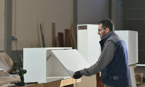 Carpenter finishing a furniture piece