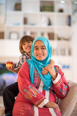 Young woman with little kid at home