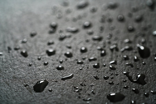 slate surface with water drops macro shot, shallow focus