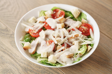 caesar salad with red cherry tomatoes, shallow focus