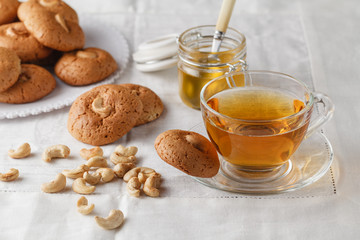 Cup of hot tea and oatmeal cookies with nuts