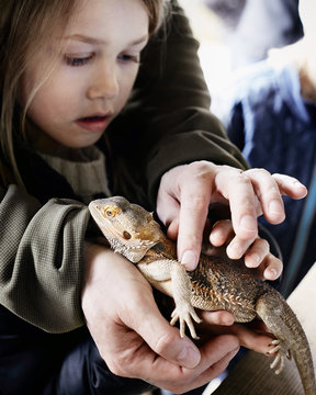 boy and father holding lizard