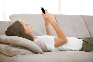 Woman holding phone on sofa