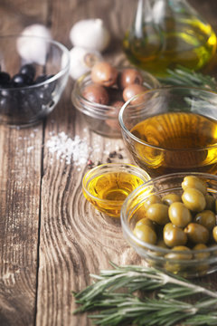 Olive oil  and olives on the wooden table