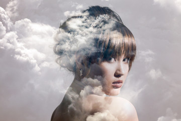 Double exposure of gorgeous bride portrait and cloudscape