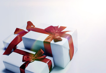 White gifts with red ribbon bow