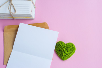 Love letter with green hearts on a pink background, empty letter