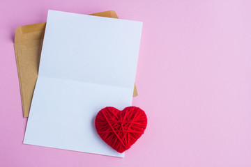 Love letter with red hearts on a pink background, empty letter