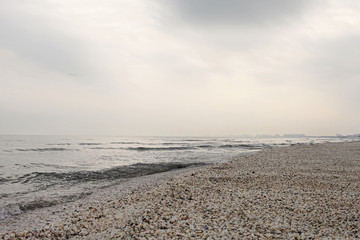 Winter black sea beach in winter sky landscape