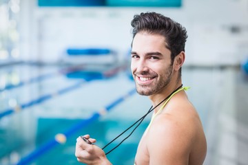 Handsome man holding stopwatch