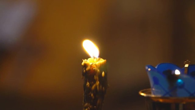 Candle Burns in The Church. Slow motion