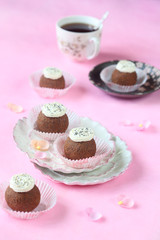 Kartoshka with poppy seeds - Traditional Russian Chocolate Sweet - on a pink background.