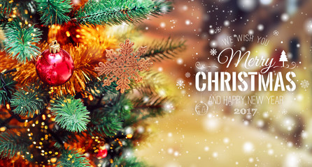Obraz na płótnie Canvas Xmas tree background and Christmas decorations with blurred, sparking, glowing and text Merry Christmas and Happy New Year. Holiday card