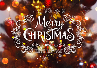 Xmas tree background and Christmas decorations with blurred, sparking, glowing and text Merry Christmas and Happy New Year. Holiday theme