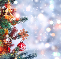 Fototapeta na wymiar Christmas tree background and Christmas decorations with snow, blurred, sparking, glowing. Happy New Year and Xmas theme