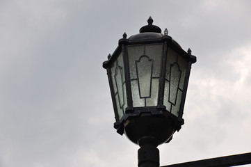 Fototapeta na wymiar Old black lantern on the dark sky