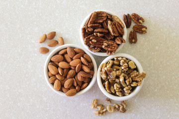 Almonds, Pecans, And Walnuts in Containers on Kitchen Countertop