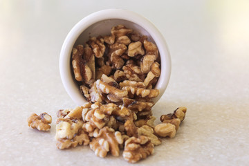 Walnuts Spilling Out Of A Container, Close Centered